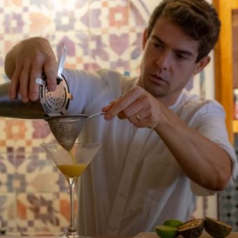 A man pouring a cocktail